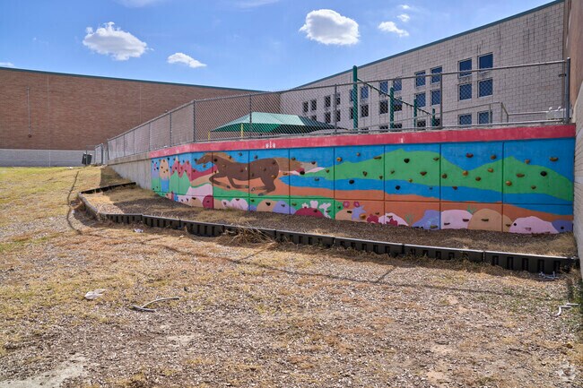 Horse mural is painted on the climbing wall outside Murchison Elementary School.