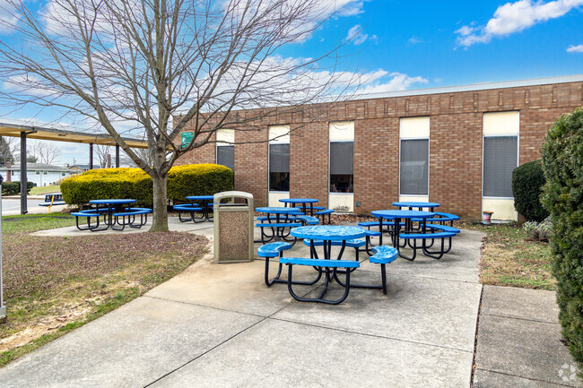 There are some picnic tables at Pearl S. Buck Elementary School.