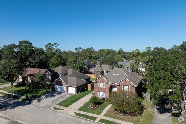 An aerial view of Humble showcases beautiful homes surrounded by lush greenery.