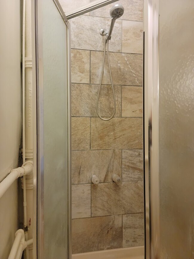 Tiled Shower and Toilet area