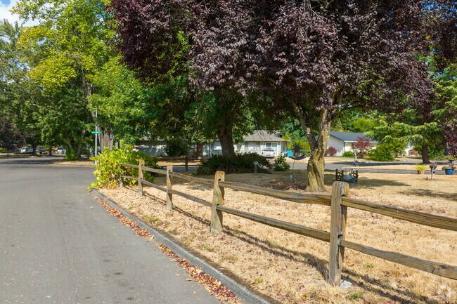 Unique kinetic art under a vibrant purple tree adds personality to Kevanna Park homes.