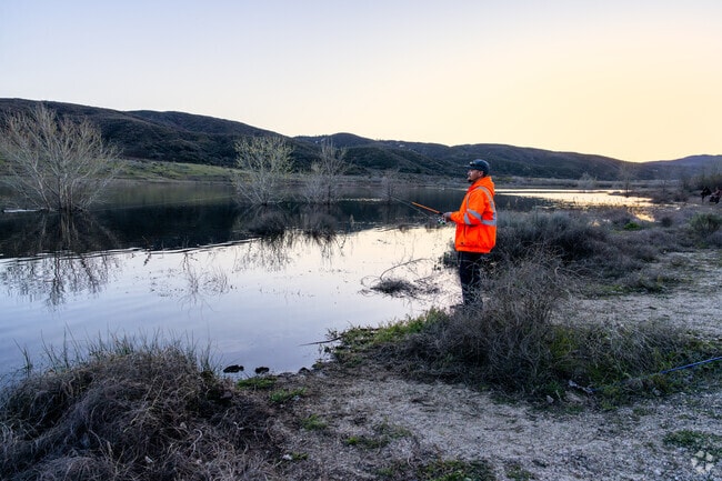 A man relaxes and spends some time fishing at the lake in Lake Elizabeth.