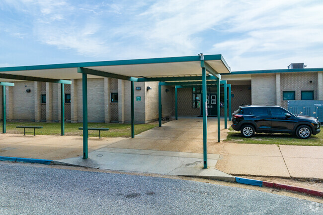 C.L. Scarborough Middle School has outdoor seating for students waiting for their bus.