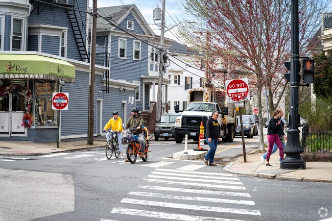 Witness the joy of family outings as they cycle along Broadway St. in Federal Hill.