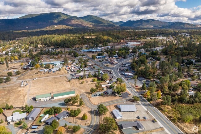 On the way into the small, rural community of Merlin, drivers pass by tree-covered hills.