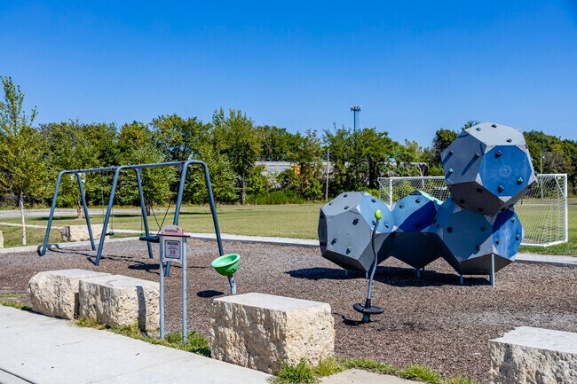 A modern playground invites local kids to climb on geometric shapes at Pulaski Park.