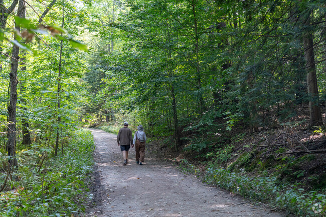 A couple strolls down a dirt trail at Hubbard Park in Park West.