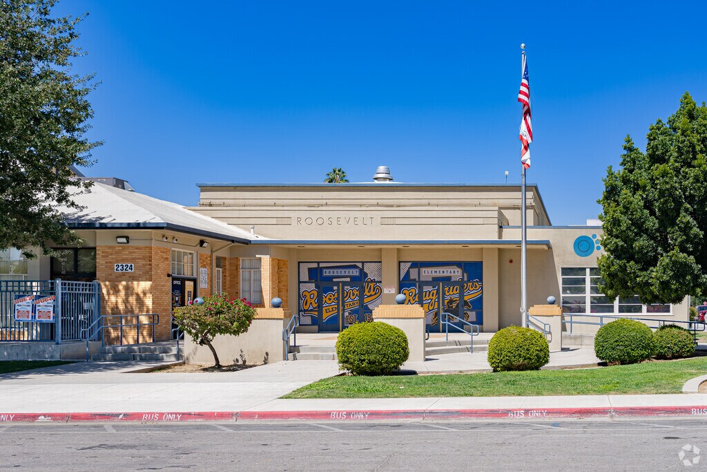 An American flag waves at the entrance to Roosevelt Elementary School in Bakersfield.