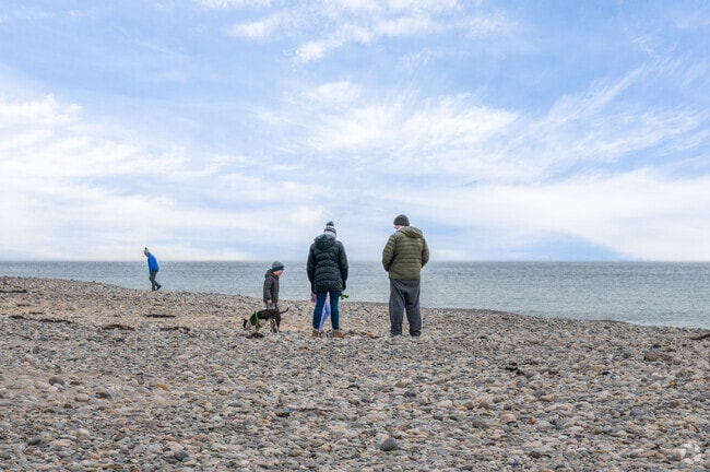 A family enjoys Humarock beach even on a cold winter day.