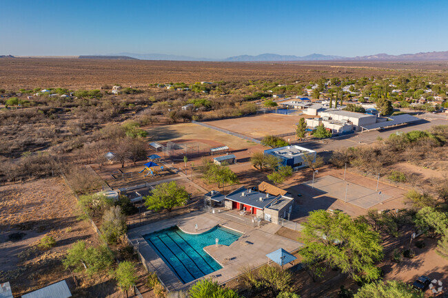 Tennis courts and play areas at Sopori Elementary School are surrounded by natural desert terrain, blending with the landscape of Arivaca Junction.