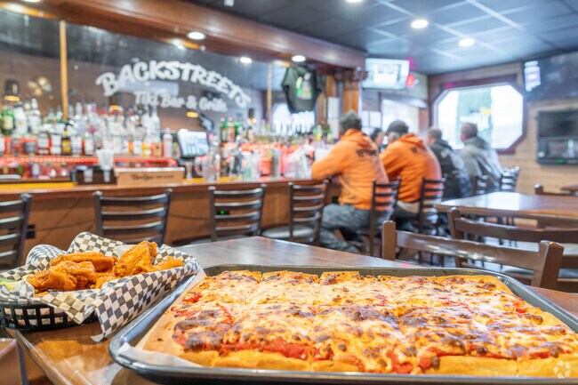 Grab a beer and a bite to eat at Backstreet's Tikki Bar and Grill provided by Grasso's Kitchen.