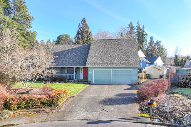 This green rancher-style home in West Hillsboro features a two-car garage.