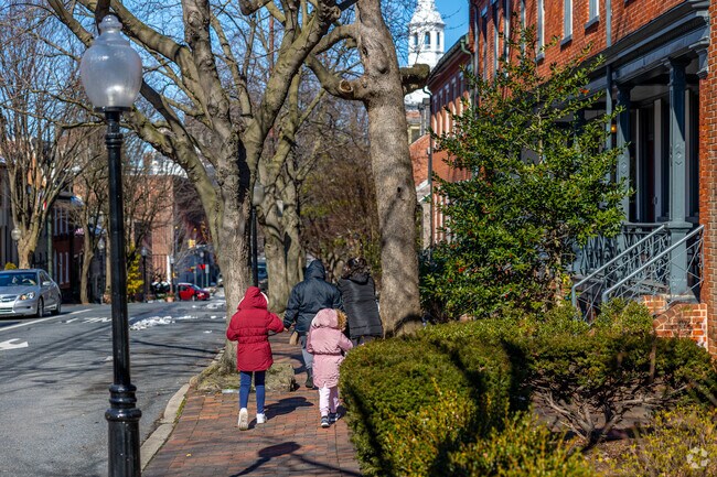 Walk along historic brick paved sidewalks next to Mussertown historical colonial row homes.