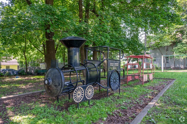 Walton Gould Children’s Park features colorful play structures, shady trees, and benches for relaxing afternoons.