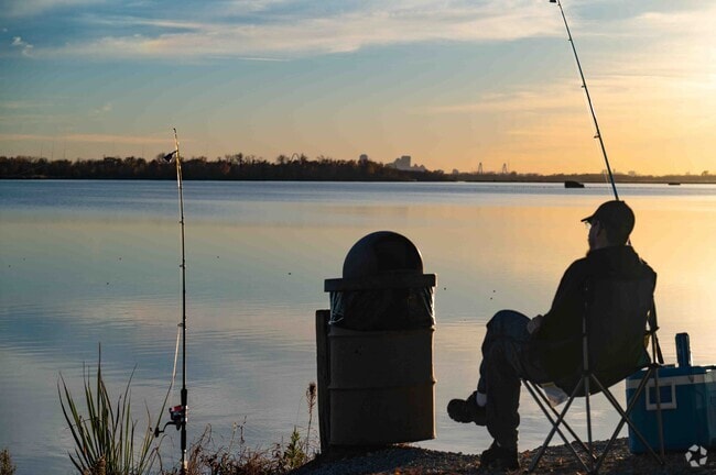 A man enjoys a quiet evening of fishing as the sun sets at Horseshoe Lake State Park.