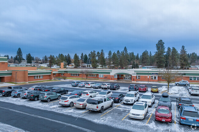 Evergreen Elementary features a medium sized parking lot in front of the school.