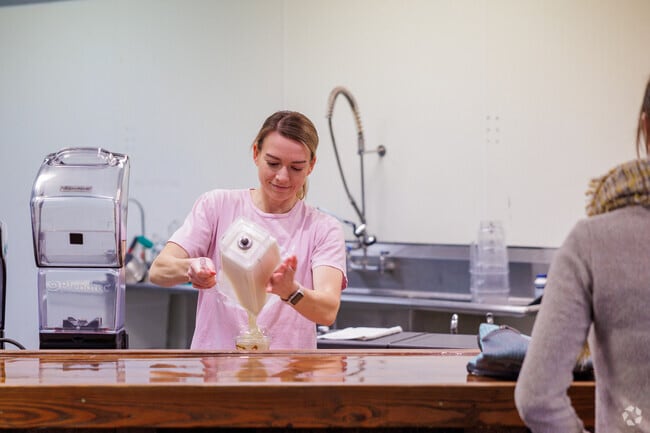 A barista at Healthy Edge serves up a fresh smoothie in the Kickapoo neighborhood.