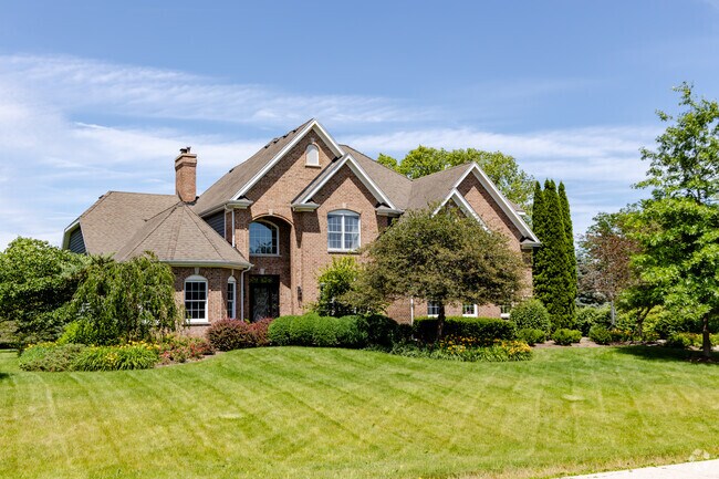 A brick, large traditional style home with a large front yard is located in Otter Creek.