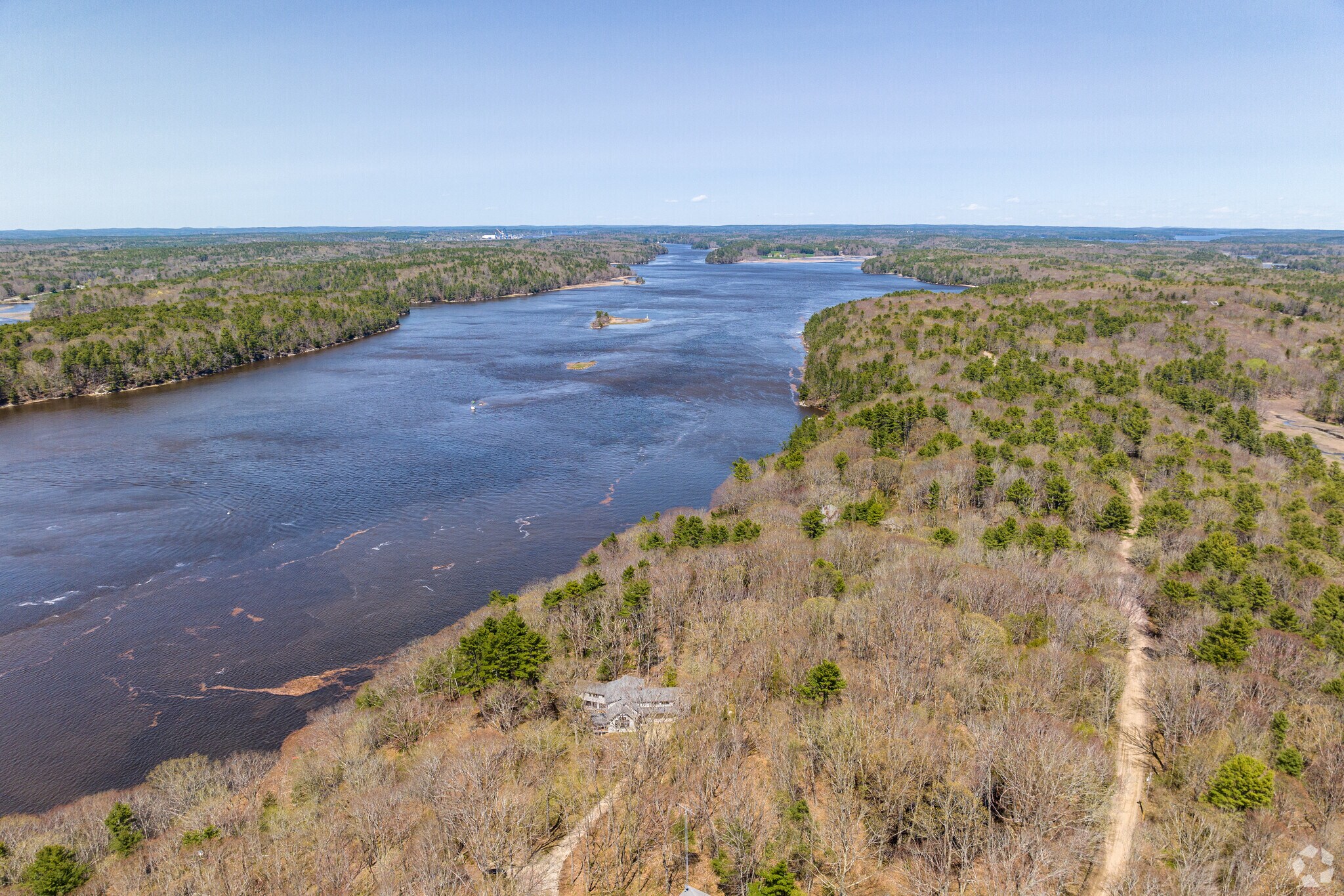 Aerial view of a home on a large lot of land that sits along the Kennebec River in Arrowsic, Maine.