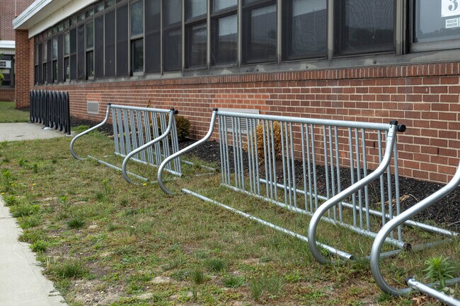 There are bicycle racks outside of Babylon Memorial Grade School in Babylon, NY.