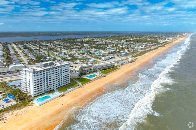 Condos along the sandy shore in Ormond By The Sea offer ocean views and beach access.