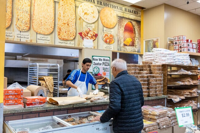 A man buys bread at the Balboa International Market in Clairemont Mesa West.