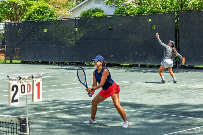Tennis players rally and compete on Pinehurst’s sunlit clay courts.