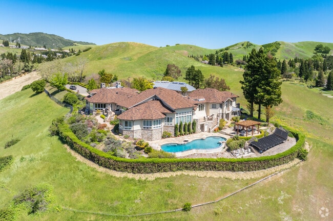 A hill top luxury estate rests atop a hill in a private setting within Blackhawk.