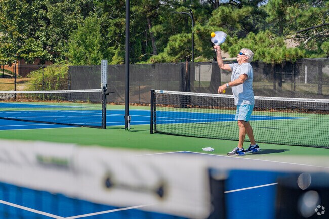 Residents can use the pickle ball courts at the Royal Lakes Center to practice their swing.