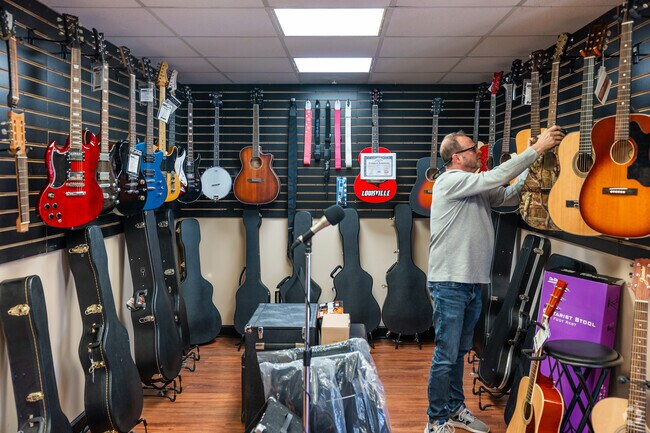 A man in MDS Music picks out a guitar.