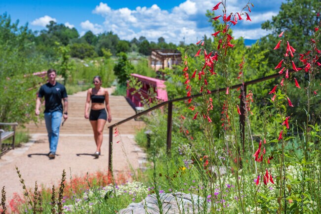 A couple enjoy a walk on a lovely day at the Santa Fe Botanical Gardens.