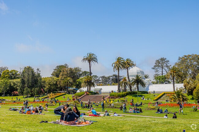 People enjoy a warm summer day at Golden Gate Parks Conservancy Of Flowers.