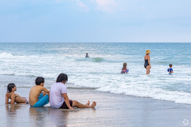 A family from Eastwind-Piney Acres enjoys a day at Wrightsville Beach.