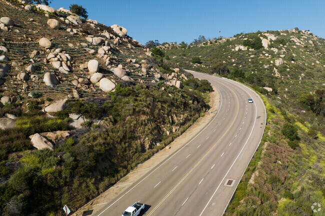 The single road into Hidden Meadows has rolling hills and boulders.
