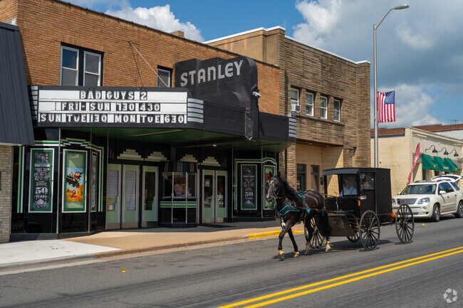 A horse and buggy trots past the historic Stanley Theater, which has served the community since 1936.