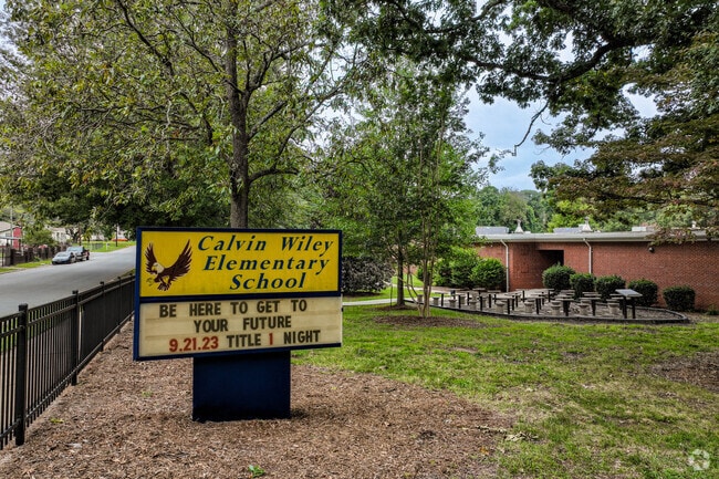 The sign for Calvin Wiley Elementary School is a happy bright yellow.