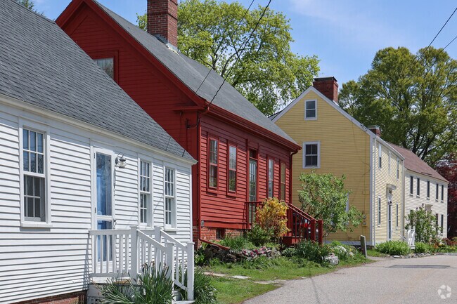 Colorful rows of historic homes brighten the charming streets of New Castle Island, adding character and vibrancy to the coastal village.