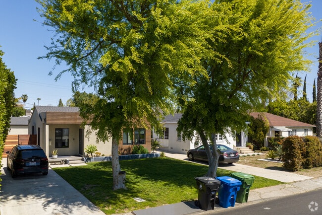 A cute modern-style home sits among traditional homes.