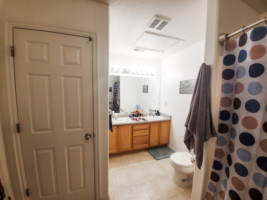 Bathroom with double vanity and entrance from master and hallway