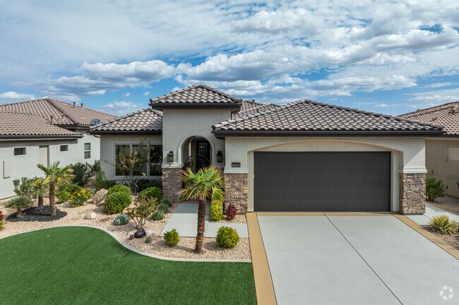 Homes in Sunbrook have well-kept front lawns and multi-car garages.