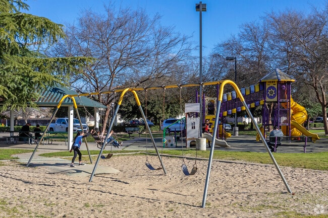Families enjoy the large playground at John F. Kennedy Park in Sanger.