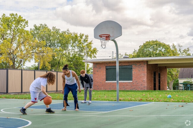 Local youths enjoy a game of basketball at a local park, located near Highland Place.