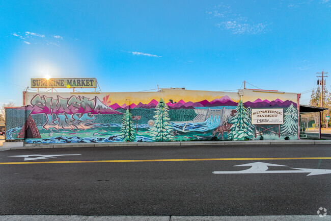 Sun sets over beautiful mural on Sunrise Market in Shasta Lake.