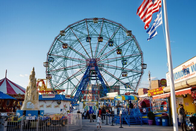Families enjoy vibrant rides at Coney Island's iconic Luna Park.