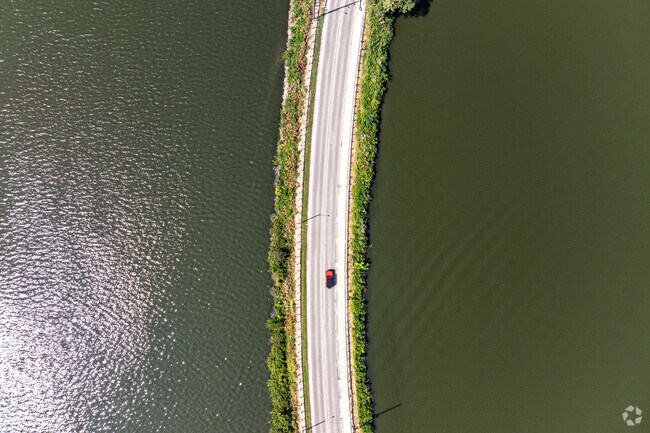 A car travels the scenic Lost Bridge Road which runs through the Greenlake area of Decatur, IL.