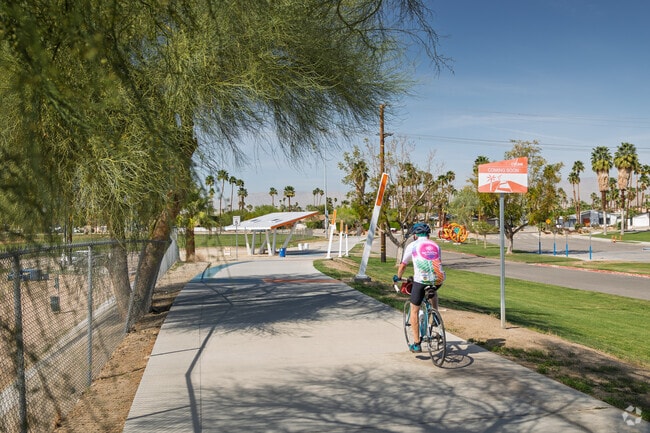 Ride along the Tahquitz Creek Loop bike trail near Los Compadres.