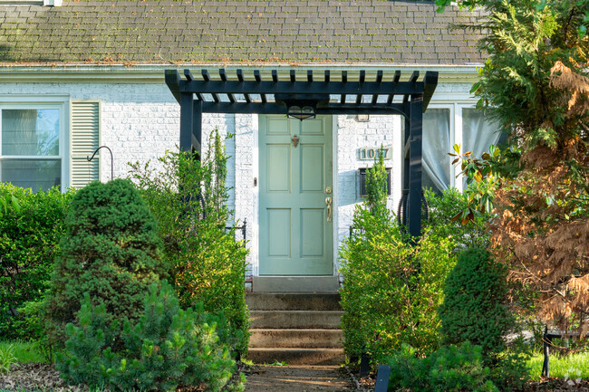 Pergolas cover the walkways through the lush gardens of Crestwood homes.