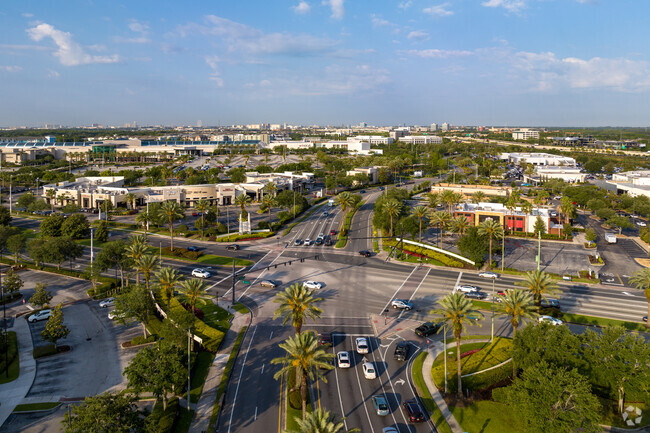 A four-way intersection marks the entrance to the Mall of Millenia shopping and parking.