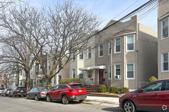 Many of Maspeth's streets are lined with trees providing shade for street-parked cars.