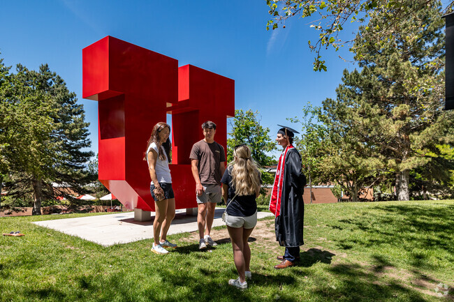 A University of Utah graduate celebrates with friends in the University neighborhood.